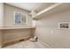 Bright laundry room with built-in shelving and window at 1555 Rosedale St, Castle Rock, CO 80104