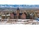 Aerial view of a school building with a clock tower, surrounded by snowy landscape at 2865 S Pancratia St, Denver, CO 80236