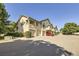 Townhouse-style building with attached garages and landscaping at 8767 E Dry Creek Rd # 1312, Englewood, CO 80112