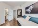 Guest bedroom with access to full bath and wood floors at 8767 E Dry Creek Rd # 1312, Englewood, CO 80112