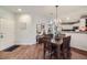 Well-lit dining area with hardwood floors and kitchen access at 8767 E Dry Creek Rd # 1312, Englewood, CO 80112