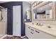 Bathroom with double vanity, large mirror, and shower/tub combo at 8767 E Dry Creek Rd # 1312, Englewood, CO 80112
