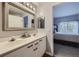 Shared bathroom with double vanity and a view of the bedroom at 8767 E Dry Creek Rd # 1312, Englewood, CO 80112