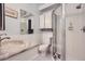 Clean bathroom with white tile, marble vanity, and a shower/tub combo at 1155 N Ash St # 1504, Denver, CO 80220