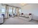 Living room with a daybed and access to balcony with city views at 1155 N Ash St # 1504, Denver, CO 80220