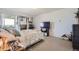 Spacious bedroom with large TV, carpeted floors, and plenty of natural light at 1155 N Ash St # 1504, Denver, CO 80220