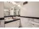 Bathroom with marble vanity, white cabinets and a large mirror at 1155 N Ash St # 1504, Denver, CO 80220