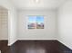 Bright bedroom with dark hardwood floors and spacious closet at 5083 Perth Ct, Denver, CO 80249