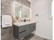 Modern bathroom with gray vanity, a large mirror, and stylish tilework at 5886 S Logan St, Centennial, CO 80121