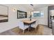 Dining area with a modern wood table, neutral chairs, and a built-in bar at 5886 S Logan St, Centennial, CO 80121