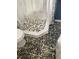 Bathroom with a walk-in shower and pebble stone floor at 542 E Caley Dr, Centennial, CO 80121