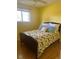 Bright bedroom with hardwood floors and a floral-patterned bed at 542 E Caley Dr, Centennial, CO 80121