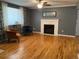 Living room featuring hardwood floors, fireplace, and comfortable seating at 542 E Caley Dr, Centennial, CO 80121