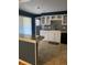 Kitchen with white cabinets, granite countertops, and black appliances at 542 E Caley Dr, Centennial, CO 80121