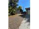 Gravel driveway with autumn leaves, leading to a garage at 542 E Caley Dr, Centennial, CO 80121