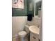 Small bathroom with white vanity and green walls at 542 E Caley Dr, Centennial, CO 80121