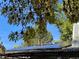 Rooftop solar panel array with tree branches in foreground at 542 E Caley Dr, Centennial, CO 80121
