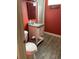Small bathroom with toilet, sink, and wood-look tile floor at 542 E Caley Dr, Centennial, CO 80121