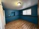 Bedroom with blue walls, wood flooring and closet at 2888 S Olathe Way, Aurora, CO 80013