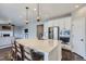 Modern kitchen with white cabinets, granite island, and stainless steel appliances at 12689 Sunset Dr, Firestone, CO 80504