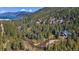 Aerial view of a house nestled near a river, surrounded by lush greenery at 189 Ginger Quill Ln, Breckenridge, CO 80424