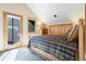 Bright bedroom with a queen bed, access to a private deck, and ample closet space at 189 Ginger Quill Ln, Breckenridge, CO 80424