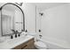 Clean bathroom with a bathtub, toilet, and modern vanity at 11830 E Canal Dr, Aurora, CO 80011