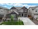 Two-story home with gray siding, stone accents, and a landscaped yard at 890 Meadowlark Dr, Erie, CO 80516