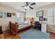 Bedroom with wooden bed frame and home office space at 2891 Canyon Crest Dr, Highlands Ranch, CO 80126