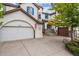 Two-story house with white exterior, blue shutters, and a two-car garage at 2891 Canyon Crest Dr, Highlands Ranch, CO 80126