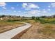 Paved walking path with views of homes and open space at 2891 Canyon Crest Dr, Highlands Ranch, CO 80126