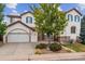 Two-story house with white exterior, blue shutters, and a two-car garage at 2891 Canyon Crest Dr, Highlands Ranch, CO 80126