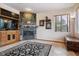 Gathering room with a corner fireplace and built-in entertainment center at 2891 Canyon Crest Dr, Highlands Ranch, CO 80126