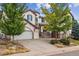 Two-story house with white exterior and double garage at 2891 Canyon Crest Dr, Highlands Ranch, CO 80126