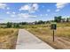 Paved community trail leading through open green space at 2891 Canyon Crest Dr, Highlands Ranch, CO 80126