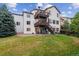 Rear view of two story home with deck and landscaping at 2891 Canyon Crest Dr, Highlands Ranch, CO 80126