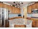 Kitchen island with granite countertops and wood cabinets at 2891 Canyon Crest Dr, Highlands Ranch, CO 80126