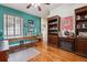 Bright office with teal walls and built-in shelving at 2891 Canyon Crest Dr, Highlands Ranch, CO 80126