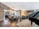 Open concept dining area with a kitchen view, hardwood floors, and modern light fixtures at 8085 S Spruce Cir, Centennial, CO 80112