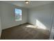 Well-lit bedroom featuring carpet and a window at 5571 Wisteria Ave, Firestone, CO 80504