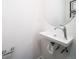 Small powder room with floating vanity and round mirror at 45024 Sunflower Ln, Bennett, CO 80102