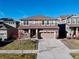 Two-story house on a quiet street with a two-car garage and front yard at 9299 Rifle St, Commerce City, CO 80022