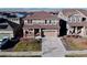 Two-story house with a two-car garage, front porch, and manicured lawn at 9299 Rifle St, Commerce City, CO 80022