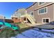 Backyard with patio, deck, and playset at 9299 Rifle St, Commerce City, CO 80022