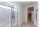 Bathroom with shower, walk-in closet, and tiled floor at 9299 Rifle St, Commerce City, CO 80022