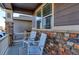 Charming front porch with rocking chairs and brick accents at 9299 Rifle St, Commerce City, CO 80022
