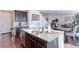 Kitchen island with granite countertop and double sink, open to dining area at 9299 Rifle St, Commerce City, CO 80022