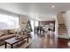 Open concept living and kitchen area with hardwood floors at 9299 Rifle St, Commerce City, CO 80022
