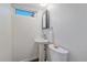 Clean basement bathroom with pedestal sink and toilet at 3744 Miller Ct, Wheat Ridge, CO 80033