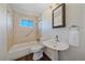 Clean bathroom with pedestal sink and shower/tub combo at 3744 Miller Ct, Wheat Ridge, CO 80033